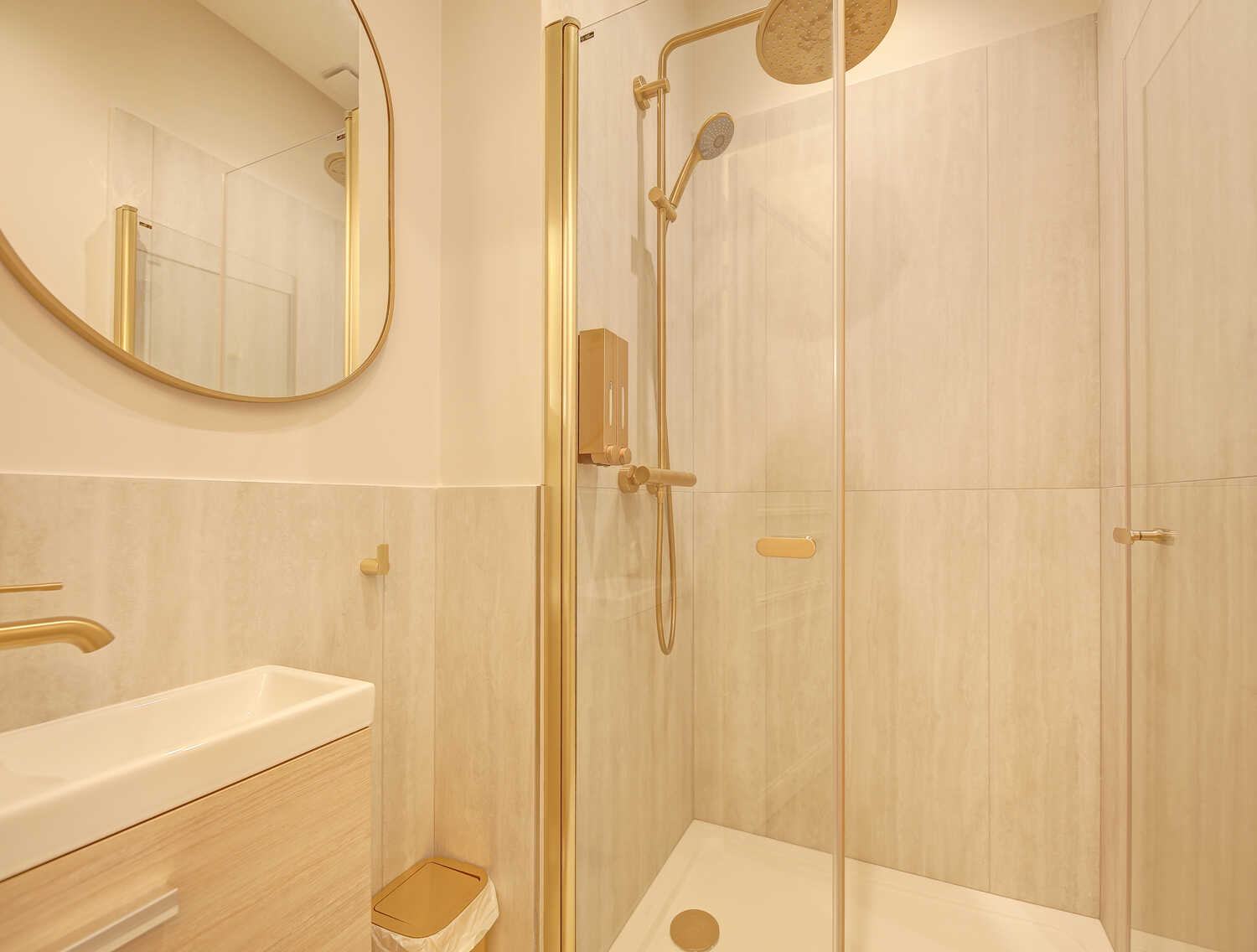 Compact bathroom with gold-framed shower